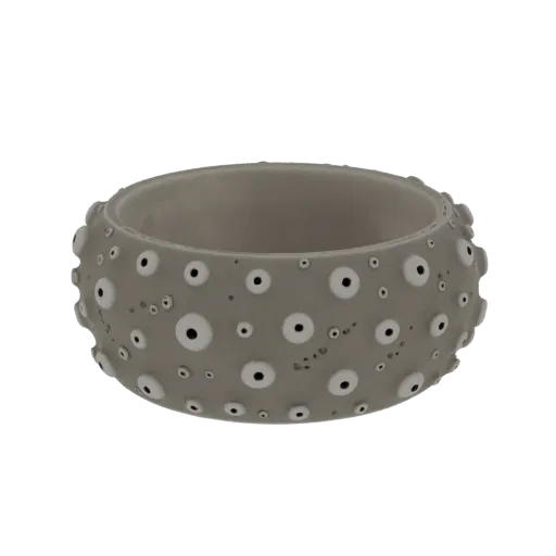 3D render of a grey bracelet with a pattern of raised white and black eye-like details, inspired by a sea urchin.