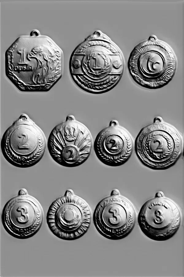 3D model of a set of 12 medals with numbers 1, 2, and 3, in bas-relief style