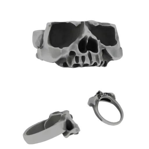 Renderização de modelo 3D de um anel de caveira detalhado, mostrado de vários ângulos contra um fundo preto.