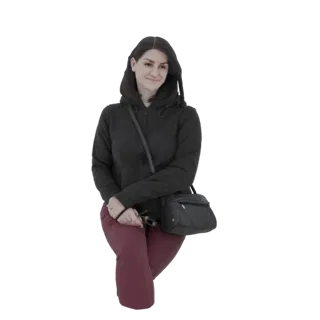 3D model of a woman with dark hair, wearing a black hoodie and maroon pants, sitting with sunglasses in hand.