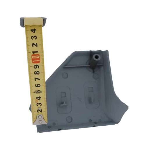 3D model of a gray plastic corner trim clip, shown with a measuring tape for scale.