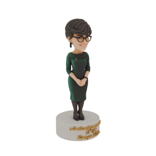 3D model of a bobblehead figure of a woman in a green dress, wearing glasses, standing on a base with Tamil inscription.