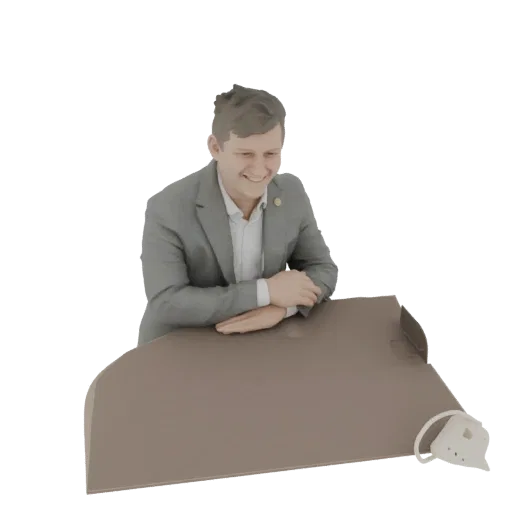 3D model of a smiling man in a grey suit leaning on a desk, isolated on a white background.
