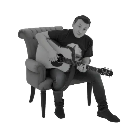 3D model of a man playing an acoustic guitar while sitting in a vintage armchair, rendered in grayscale.