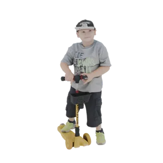 3D model of a young boy wearing a grey t-shirt and shorts, riding a yellow scooter with a black basket.