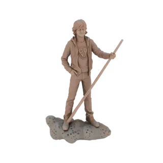 3D model of a young man with tousled hair, wearing a hoodie and jeans, holding a staff and standing on a rocky base.