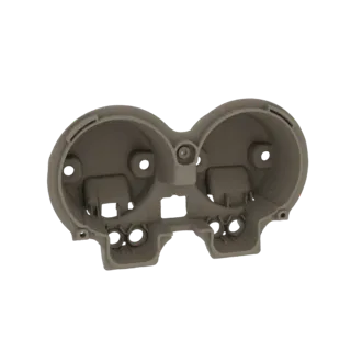 3D model of a dual gauge cluster housing with two circular openings for gauges and mounting features.