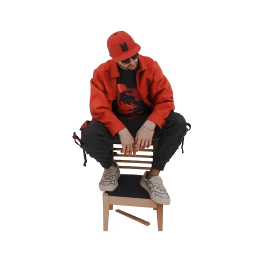 3D model of a streetwear artist wearing a red jacket and cap, sitting on a wooden chair, looking down.