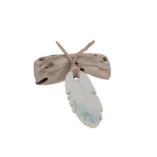 3D model of a pendant with a driftwood base and a white feather charm with blue accents, set against a white background.