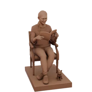 3D model of a clay-style figure of a person sitting in a chair reading a book, with a small cat at their feet.