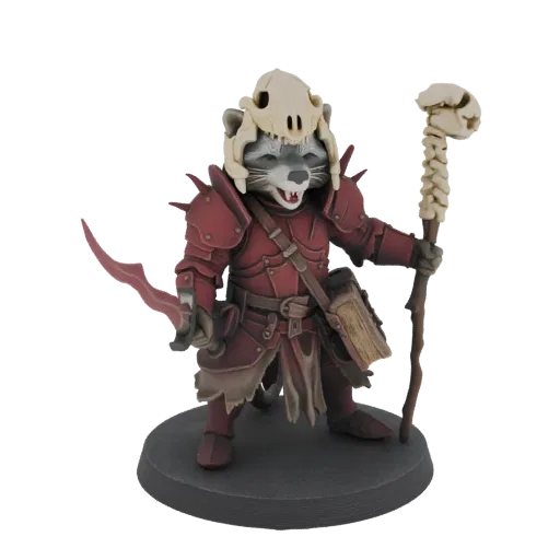 3D model of a raccoon warrior in red armor, wearing a skull helmet and holding a bone staff, standing on a base.