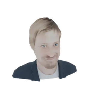 3D model of a smiling man with blonde hair and blue eyes, wearing a dark blazer and white t-shirt, against a white background