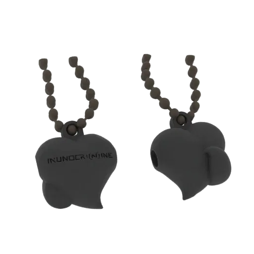 3D render of a heart-shaped pendant necklace with 'INUNOCRININE' engraved, shown from two angles against a black background.