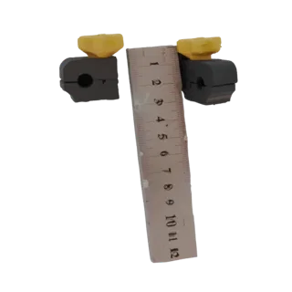 3D model preview of two black cable clamps with yellow caps, placed next to a ruler for scale reference.