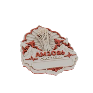 3D model of the AM2026 Org Team emblem, featuring a stylized tower, mountains, and a heartbeat line with text.