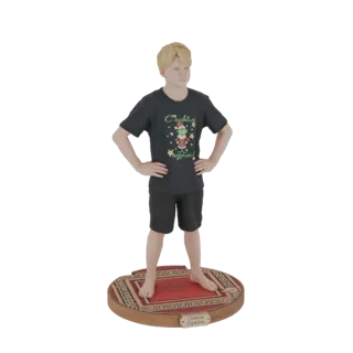 3D model of a young boy with blonde hair wearing a Christmas t-shirt and shorts, standing on a rug-patterned base.