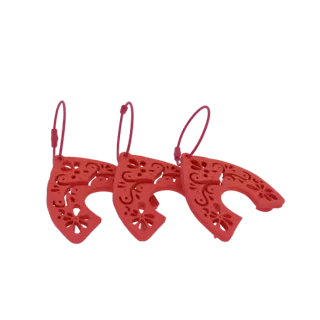 A 3D render of three red, ornate horseshoe charms with intricate floral cutouts, arranged in a row.