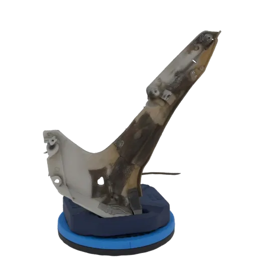 3D model of a weathered industrial metal bracket with a textured surface, mounted on a blue base.