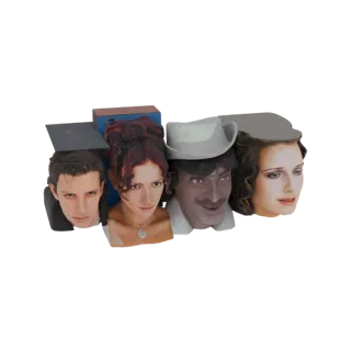 3D model of four character busts with theatrical props, including a book and hat, arranged together.