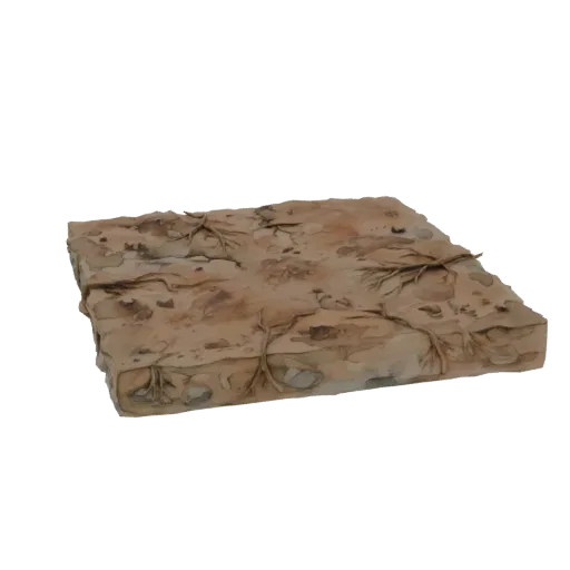 Modello 3D di blocco di terreno desertico con terra secca, ciottoli e radici vegetali rade.