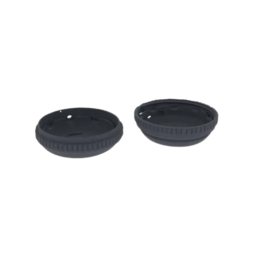 A 3D render of two dark gray plastic bottle caps, one slightly angled, against a white background.