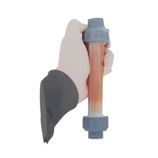 3D model of a water filter cartridge with transparent housing and orange-brown granular media, held by a hand.