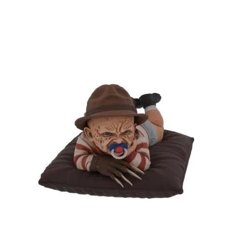 3D model of a baby dressed as Freddy Krueger, lying on a pillow with a pacifier and clawed glove.