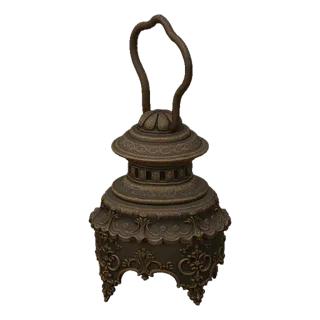 3D model of an ornate Victorian lantern with intricate scrollwork and a bronze finish, set against a black background.