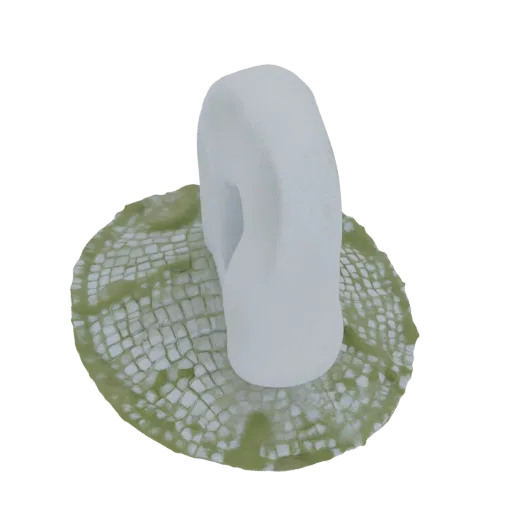 A 3D render of a smooth, white abstract sculptural form resting on a textured, green mosaic-like base against a black backgro