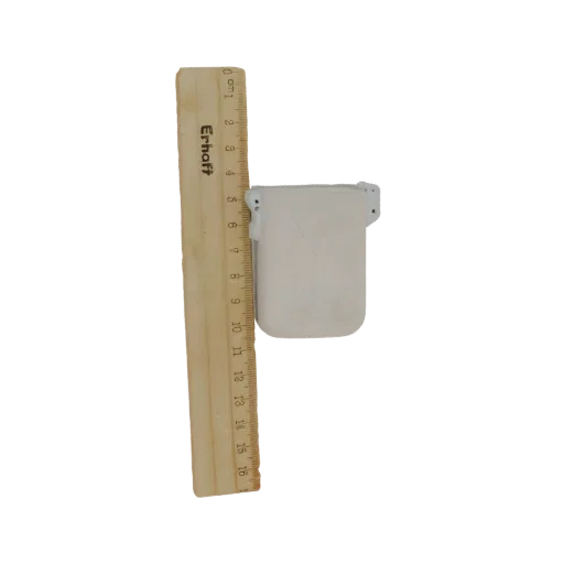 3D model of a small white container next to a wooden ruler, showing its dimensions.