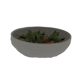 Modèle 3D d'un bol en céramique texturé rempli d'une salade verte fraîche, présenté sur fond noir.