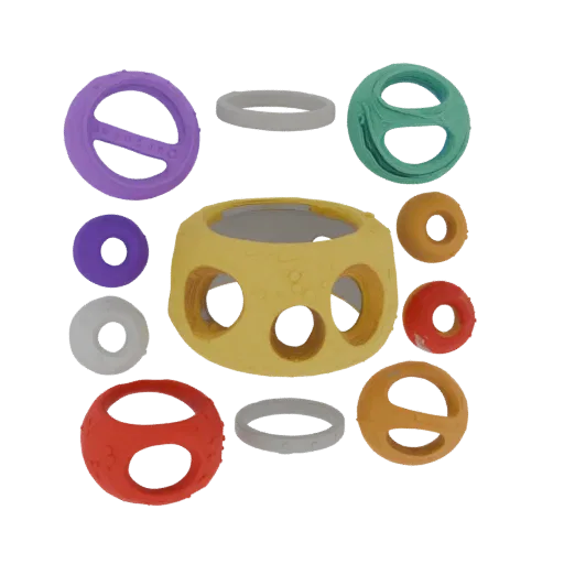 3D model of a set of colorful finger rings and a palette-shaped central element with round indentations
