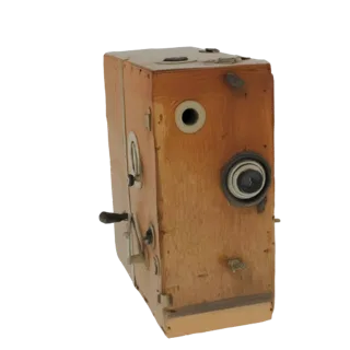 3D model of a vintage wooden box camera with a brass lens and various knobs, set against a black background.