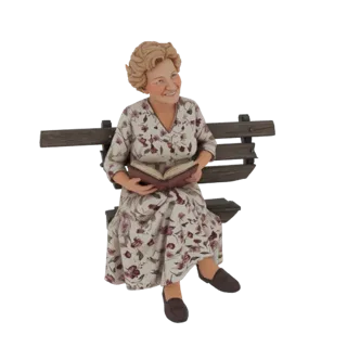 3D model of a smiling elderly woman with curly hair, wearing a floral dress and reading a book while sitting on a wooden park