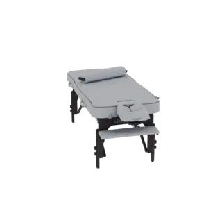 3D model of a light gray portable massage table with a face cradle and dark wooden legs, shown from a slightly elevated side
