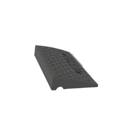 3D model of a dark gray, textured rubber wheel chock with a diamond pattern, shown from a slightly elevated side angle.
