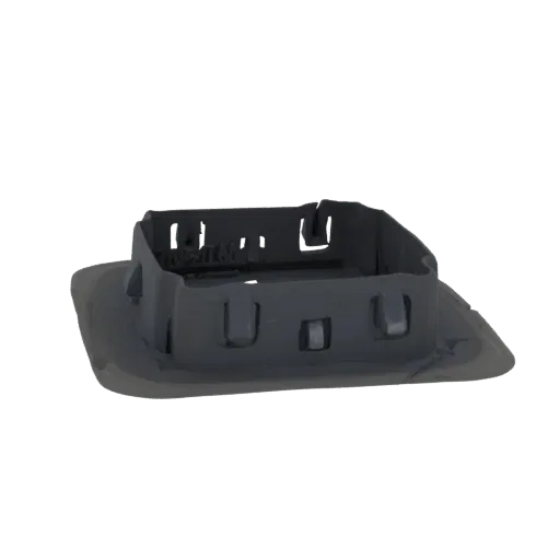 3D model of a dark gray square housing with internal clips and a raised rim, shown from a slightly elevated side angle.