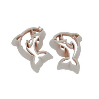 A 3D render of two light-colored dolphin-shaped cookie cutters, presented side-by-side against a white background.