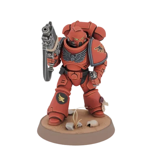 3D model of a red-armored Space Marine Warrior holding a bolter, standing on a desert-themed base.