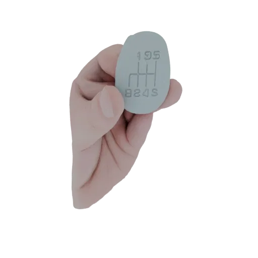 3D model of a light gray, oval-shaped 5-speed manual gear shift knob with the 'H' pattern embossed on its surface, held by a