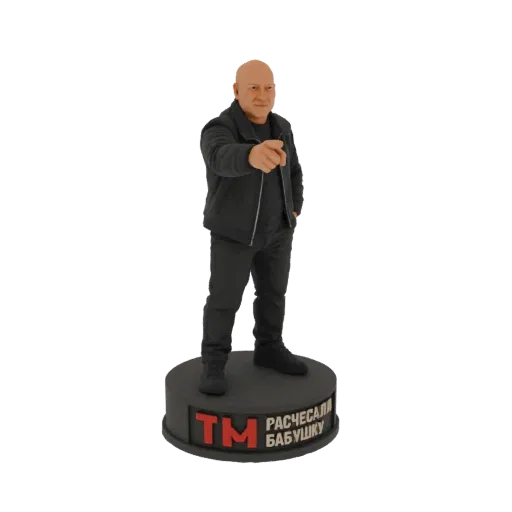 3D model of a bald man in a black jacket pointing his finger forward, standing on a circular base with Russian text.