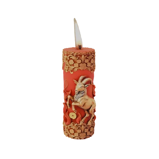 3D model of a red cylindrical candle with gold floral patterns and a central golden ram figure, representing Capricorn.