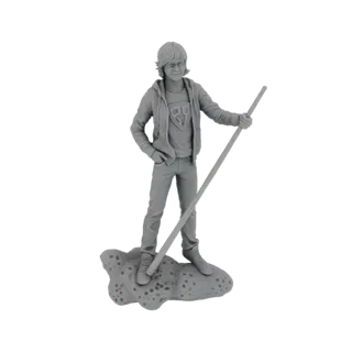 3D model render of a young boy with shaggy hair, wearing a hoodie and holding a staff, standing on a textured base.