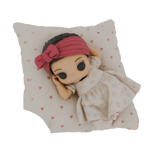 3D model of a cute baby doll with a pink headband and floral dress, sleeping peacefully on a pillow with a heart pattern.