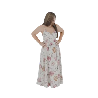 3D model of a woman wearing a flowing white maxi dress with a pink and beige floral print, standing with hands on hips.