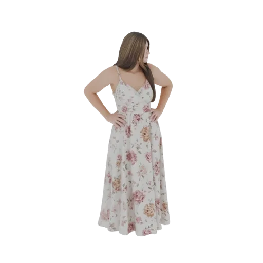 3D model of a woman wearing a flowing white maxi dress with a pink and beige floral print, standing with hands on hips.