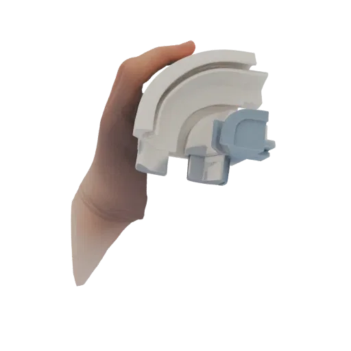 3D model of a curved track connector with a white main piece and a blue interlocking accent piece, held in a hand.