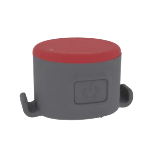 Render 3D di un dispositivo cilindrico compatto grigio con top rosso e icona pulsante, dotato di ganci laterali.