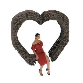 3D model of a woman in a red dress sitting on a large, rustic woven heart-shaped bench.
