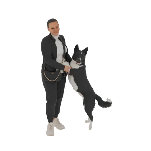 3D model of a woman in black athletic wear holding a black and white dog that is jumping up playfully.